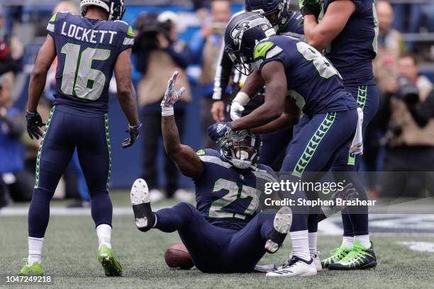 Running Back Chris Carson of the Seattle Seahawks celebrates a touchdown with teammates in the first half against the Los Angeles Rams at CenturyLink...