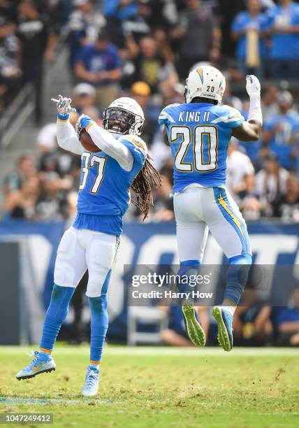 Strong safety Jahleel Addae of the Los Angeles Chargers celebrates a fumble recovery with defensive back Desmond King in the second quarter against...