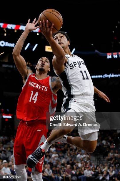 Bryn Forbes of the San Antonio Spurs shoots around Gerald Green of the Houston Rockets during a preseason game on October 7, 2018 at the AT&T Center...