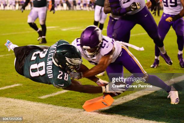 Running back Wendell Smallwood of the Philadelphia Eagles scores a two-point conversion against cornerback Mike Hughes of the Minnesota Vikings...