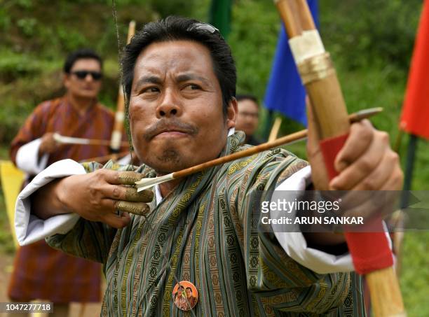In this photo taken on August 25 a Bhutanese archer aims at a target at the Changlimithang Archery Ground in Thimphu. - The traditional sport is a...