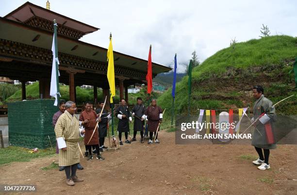 In this photo taken on August 25 president of the Bhutan Indigenous Games and Sports Association , Kinzang Dorji , interacts with archers during a...