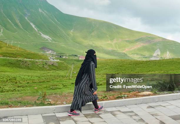 Female Arabic Tourist is wearing Burka at the Jvari Pass on August 07, 2018 in Gudauri, Georgia.