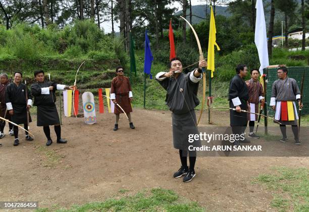 In this photo taken on August 25 a Bhutanese archer aims at a target at the Changlimithang Archery Ground in Thimphu. - The traditional sport is a...