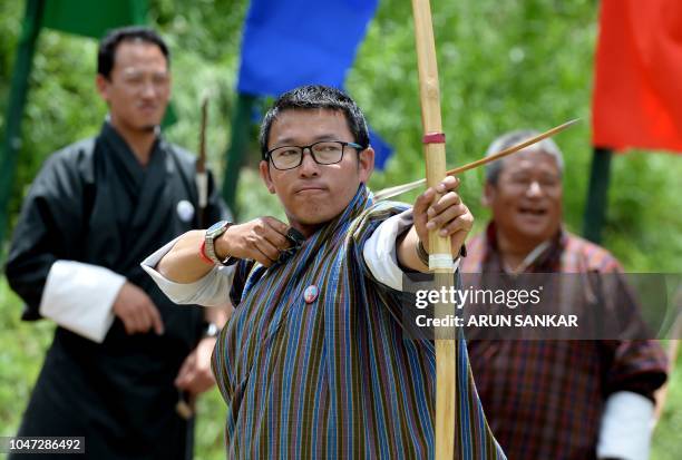 In this photo taken on August 25 Bhutanese archer Karma Tshering , winner of the practice tournament, shoots an arrow at the Changlimithang Archery...