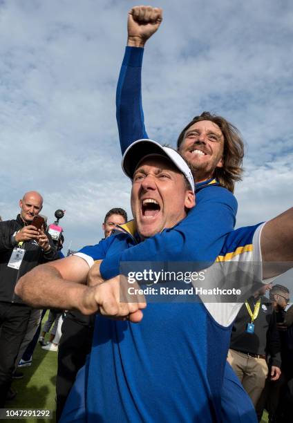 Ian Poulter and Tommy Fleetwood celebrate victory after the singles matches of the 2018 Ryder Cup at Le Golf National on September 30, 2018 in Paris,...