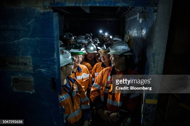 Workers prepare to ride an elevator down to the underground mining project at the Oyu Tolgoi copper-gold mine, jointly owned by Rio Tinto Group's...