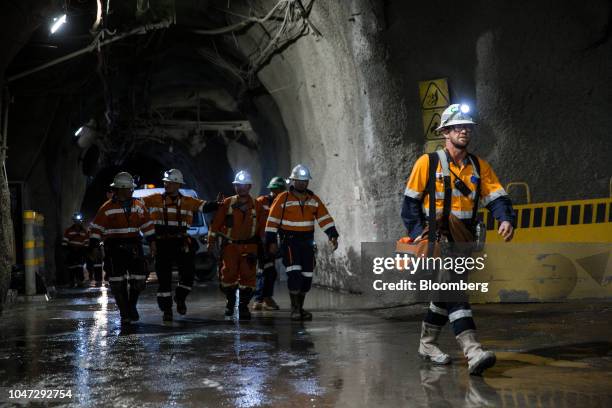 Workers walk through a tunnel towards elevators following a shift in the underground mining project at the Oyu Tolgoi copper-gold mine, jointly owned...