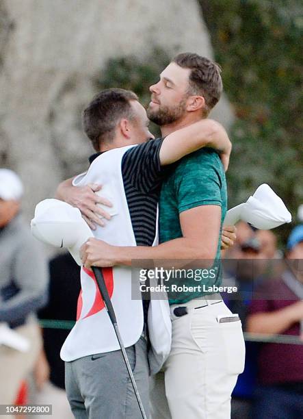 Kevin Tway reacts with his caddie Marc Sambol after putting in to win on a third hole sudden death playoff against Ryan Moore on the 10th green...