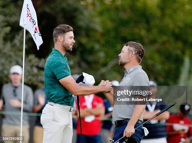 Kevin Tway shakes hands with Ryan Moore after putting in to win on a third hole sudden death playoff on the 10th green during the final round of the...