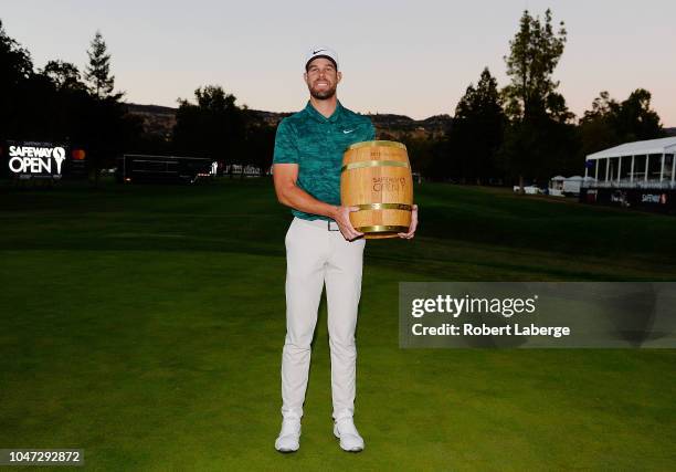 Kevin Tway poses with the trophy after putting in to win on a third hole sudden death playoff against Ryan Moore during the final round of the...