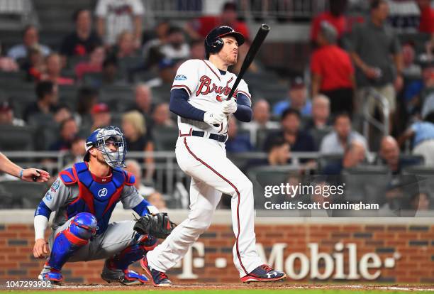 Freddie Freeman of the Atlanta Braves reacts after hitting a solo home run in the sixth inning against the Los Angeles Dodgers during Game Three of...