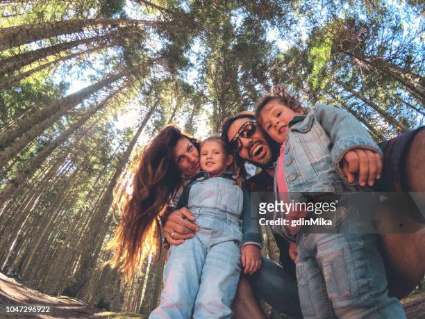 family on picnic in a forest taking selfie group portrait - family wide angle stock pictures, royalty-free photos & images