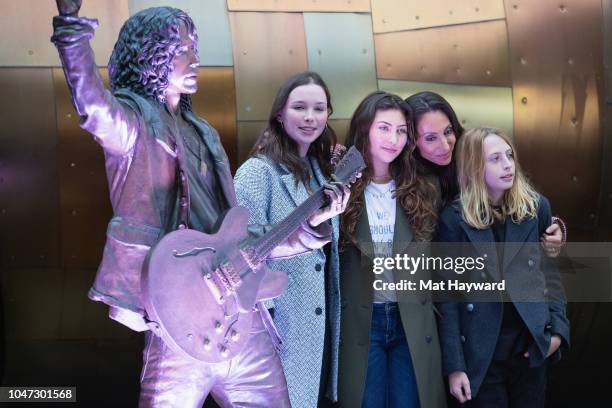 Lily Cornell, Toni Cornell, Vicky Cornell and Christopher Cornell unveil a life-size statue of singer Chris Cornell during the public unveiling...