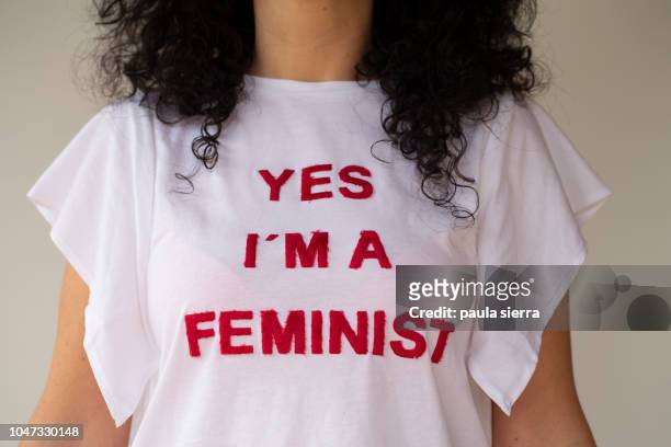 woman wearing a feminist tshirt - feminismo fotografías e imágenes de stock