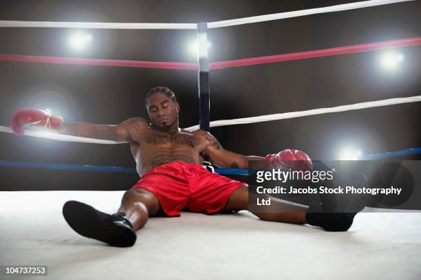 african american boxer laying in boxing ring - knockout punch stock pictures, royalty-free photos & images