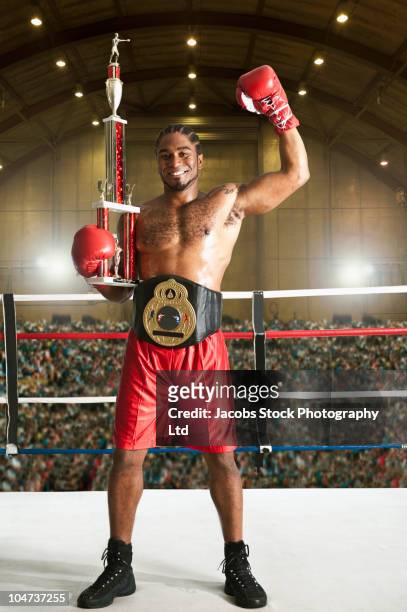 winning african american boxer in boxing ring - championship ring foto e immagini stock