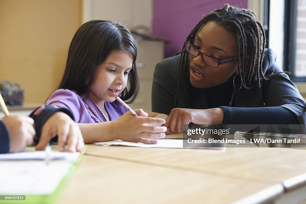 Teacher helping student with school work