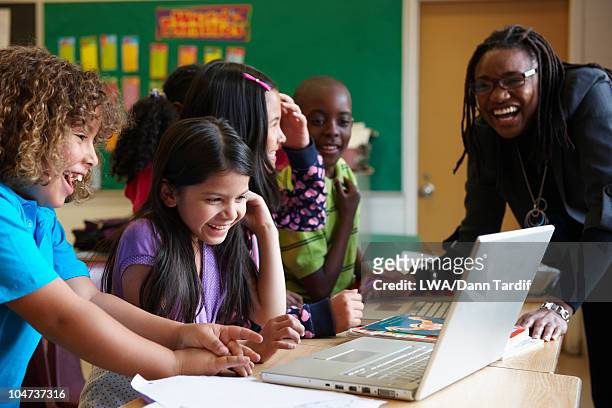 students using laptop in classroom - combine day 6 stock-fotos und bilder