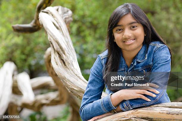 indian girl leaning on tree branch - 11 year old indian girl stock pictures, royalty-free photos & images