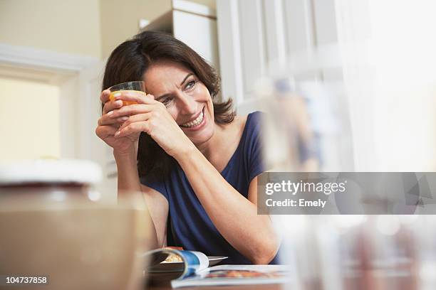 woman holding glass - orange juice glass white background stock pictures, royalty-free photos & images