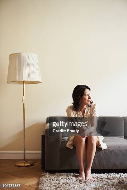 woman sitting on couch - bavarian man in front of house stock-fotos und bilder