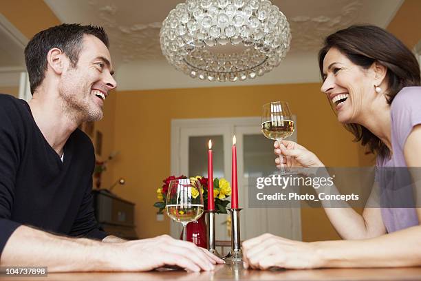 man and woman having glass of wine - table for two home stock pictures, royalty-free photos & images