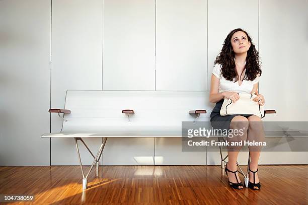 young woman in modern waiting room - job search stress stock pictures, royalty-free photos & images