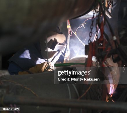 Worker welding in a power station