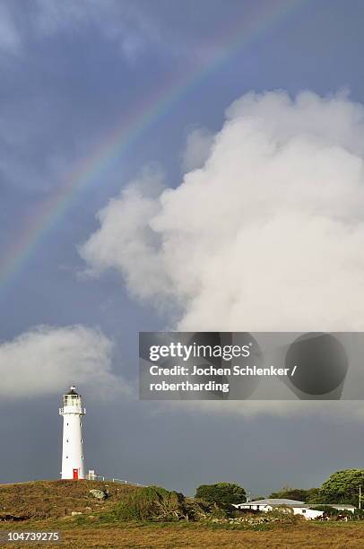 rainbow and cape egmont lighthouse, taranaki, north island, new zealand, pacific - cape egmont lighthouse stock pictures, royalty-free photos & images