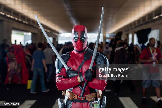 Fan cosplays as Deadpool from the Marvel Universe during the 2018 New York Comic-Con at Javits Center on October 7, 2018 in New York City.