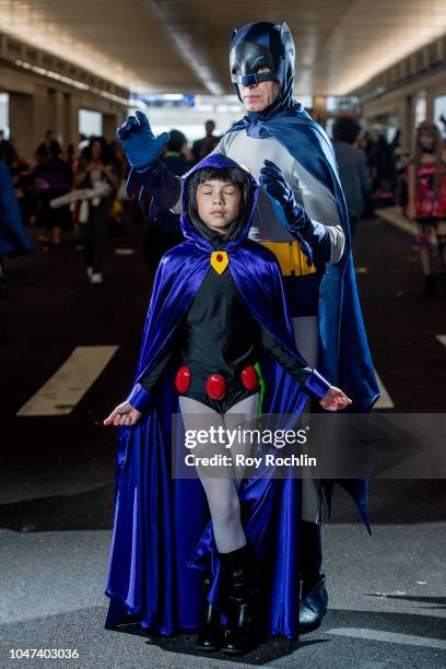 Fans cosplay as Raven from Teen Titans Go and Adam West Batman form the DC Universe during the 2018 New York Comic-Con at Javits Center on October 7,...