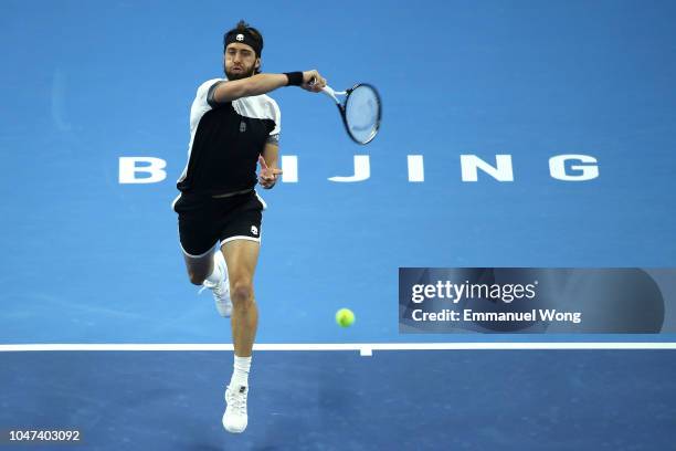 Nikoloz Basilashvili of Georgia hits a return against Juan Martin Del Potro of Argentina during his Men's Singles Finals match in the 2018 China Open...