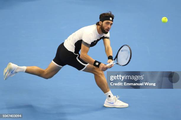 Nikoloz Basilashvili of Georgia hits a return against Juan Martin Del Potro of Argentina during his Men's Singles Finals match in the 2018 China Open...