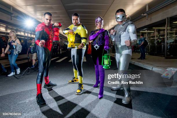 Fans cosplay as The Lanterns fromGreen Lantern from the DC Universe during the 2018 New York Comic-Con at Javits Center on October 7, 2018 in New...