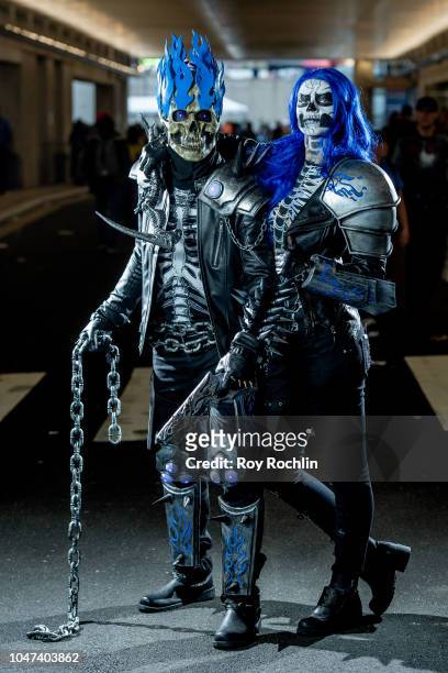 Fans cosplay as Ghost Rider and Wife form the DC Universe during the 2018 New York Comic-Con at Javits Center on October 7, 2018 in New York City.