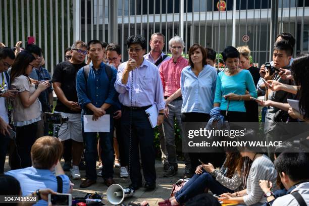 Chris Yeung , Chairperson of the Hong Kong Journalist Association, stands next to Foreign Correspondents' Club president Florence de Changy and...