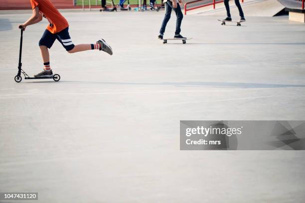 teenagers in skate park - roller skate stock-fotos und bilder