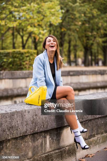 Carlotta Rubaltelli, wearing a light blue checked blazer, black shorts, black sandals with white socks and a yellow Balenciaga bag, is seen before...