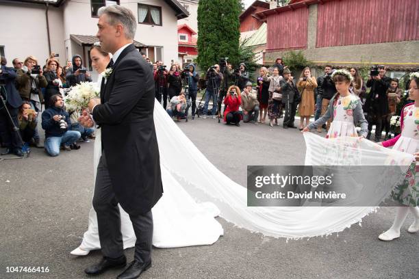 Princess Alina of Romania arrives with her godfather Liviu Popescu at Sfantul IIie church on September 30, 2018 in Sinaia, Romania.