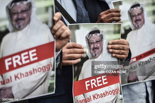 Protestors hold pictures of missing journalist Jamal Khashoggi during a demonstration in front of the Saudi Arabian consulate on October 8, 2018 in...