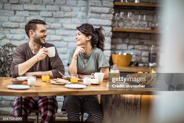 gelukkige paar te praten tijdens ochtend koffie thuis. - nachtkleding stockfoto's en -beelden