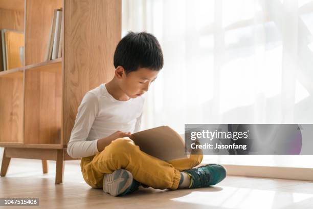 education - boy sitting on floor stock pictures, royalty-free photos & images