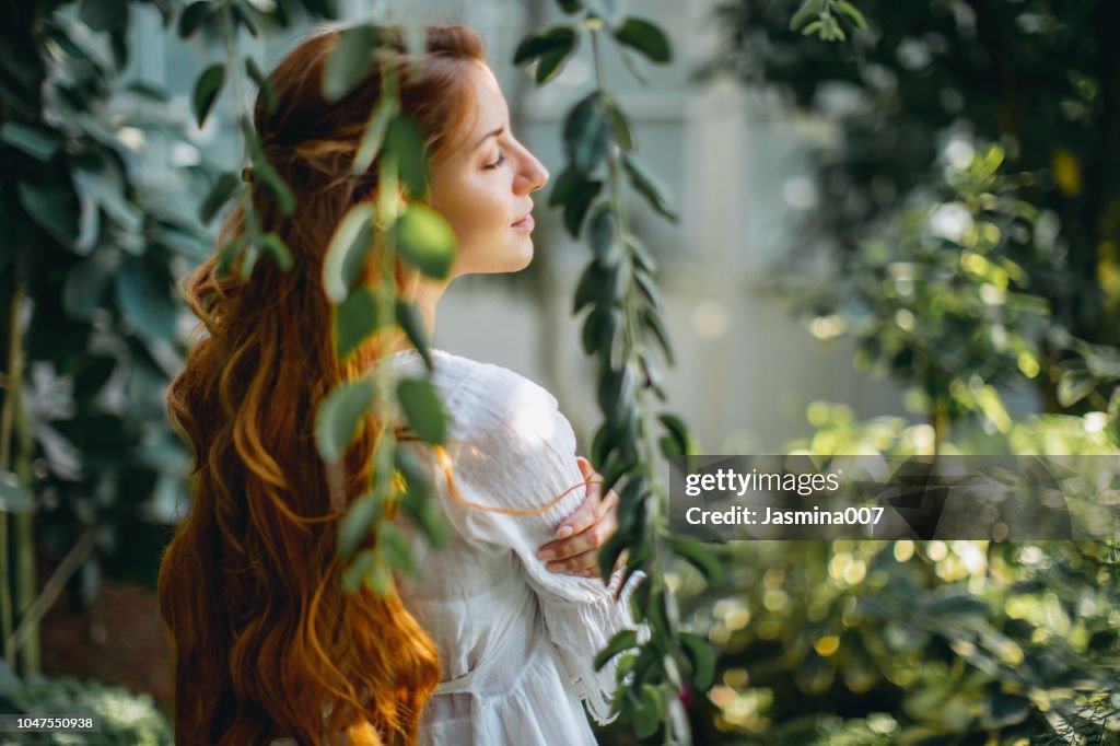 Dreamy woman in tropical environment