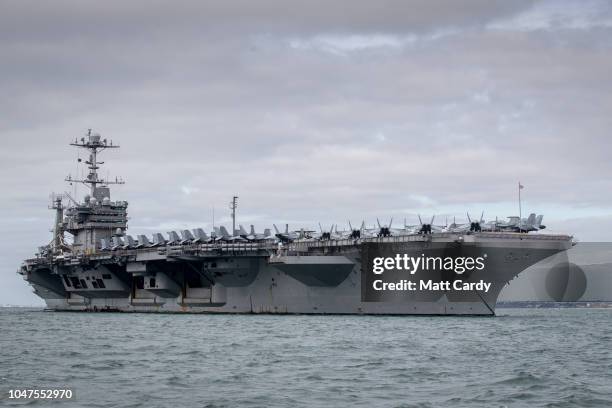 The US warship USS Harry S. Truman is pictured anchored in The Solent on October 8, 2018 near Portsmouth, England. The nuclear powered aircraft...