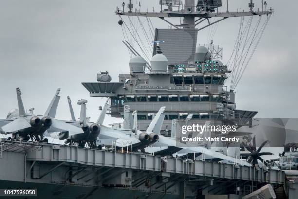 Aircraft parked on the flight deck of the US warship USS Harry S. Truman are pictured as the ship is anchored in The Solent on October 8, 2018 near...