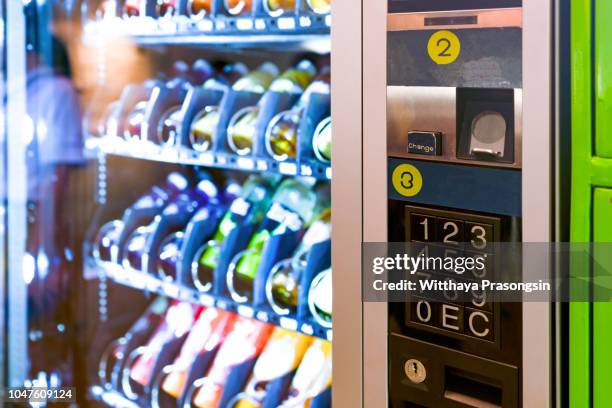 sell, technology and consumption concept - pushing button on vending machine operation panel - machinery imagens e fotografias de stock