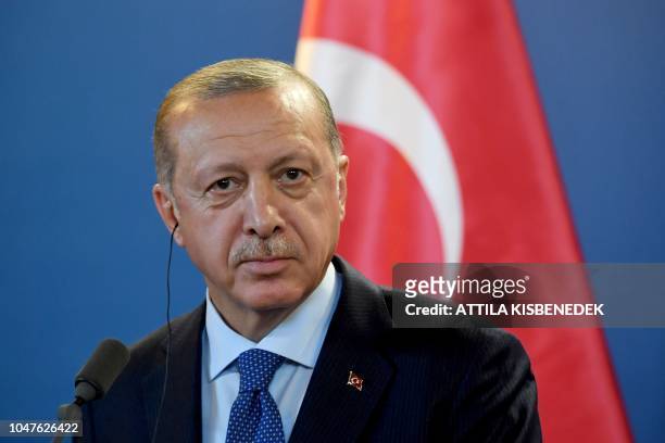 Turkish President Recep Tayyip Erdogan listens to a journalist's question during a joint press conference with the Hungarian Prime Minister after...