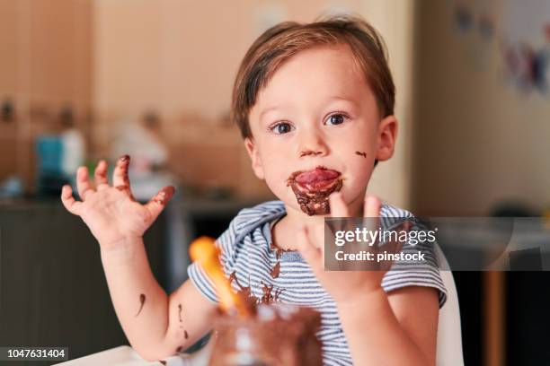 child is eating chocolate - eating chocolate stock pictures, royalty-free photos & images