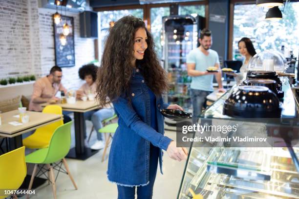 beautiful woman standing in front of showcase - sandwich shop stock pictures, royalty-free photos & images